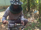 Extracting honey with a hand extractor